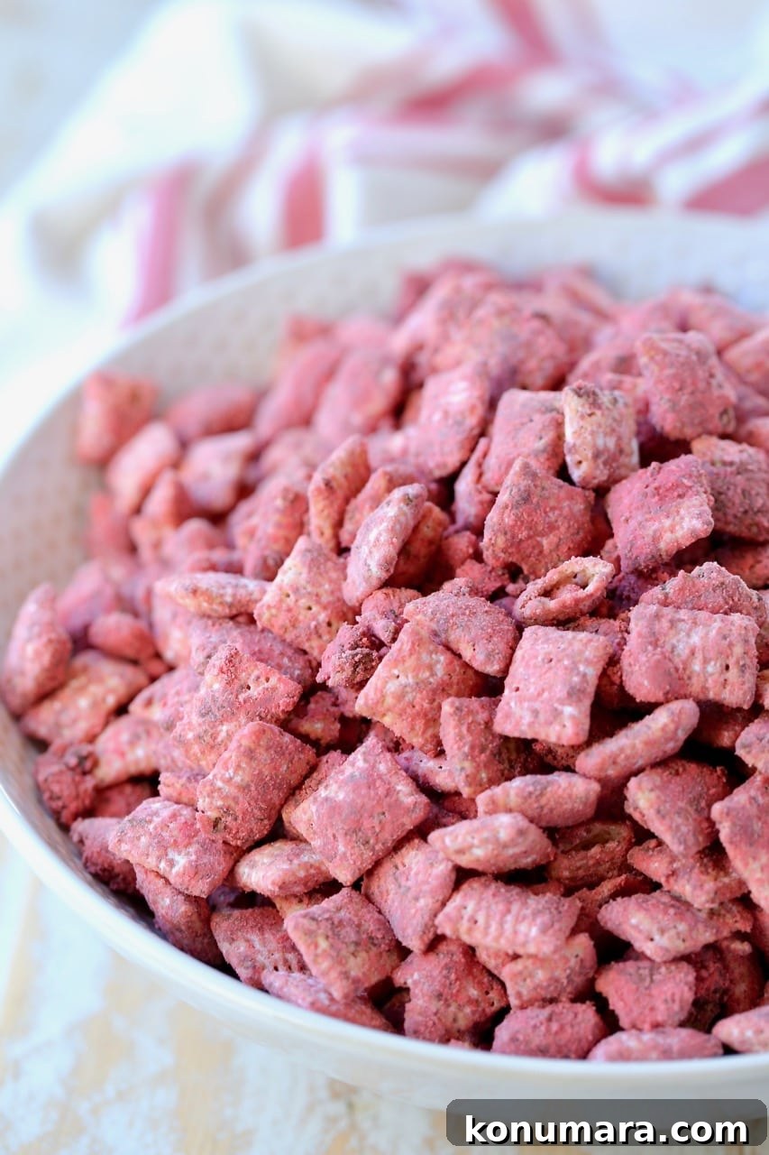 Red velvet puppy chow in white bowl with red and white striped towel