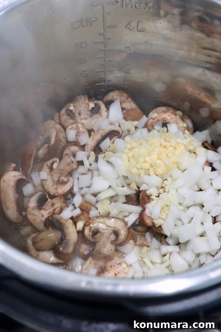 Creamy Instant Pot Chicken Stroganoff Recipe 4 diced onions, sliced mushrooms and minced garlic in an Instant Pot