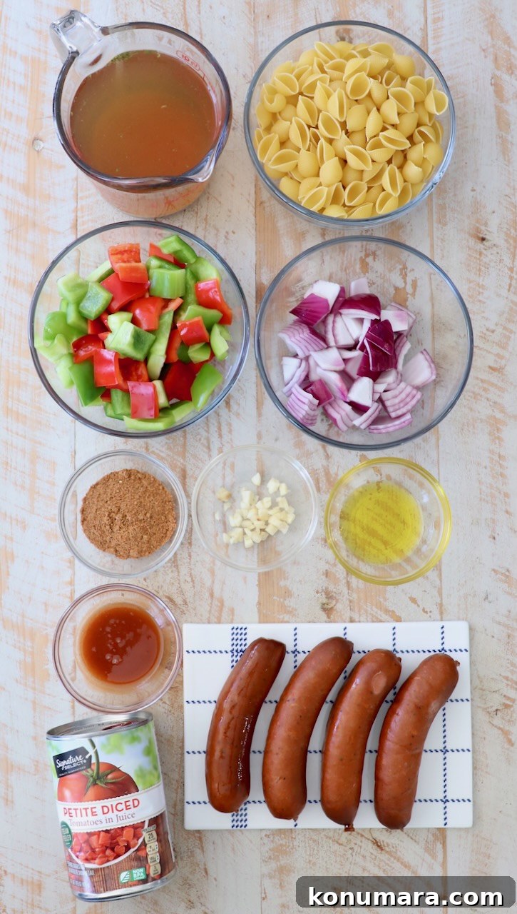 Cajun pasta ingredients on white wood board
