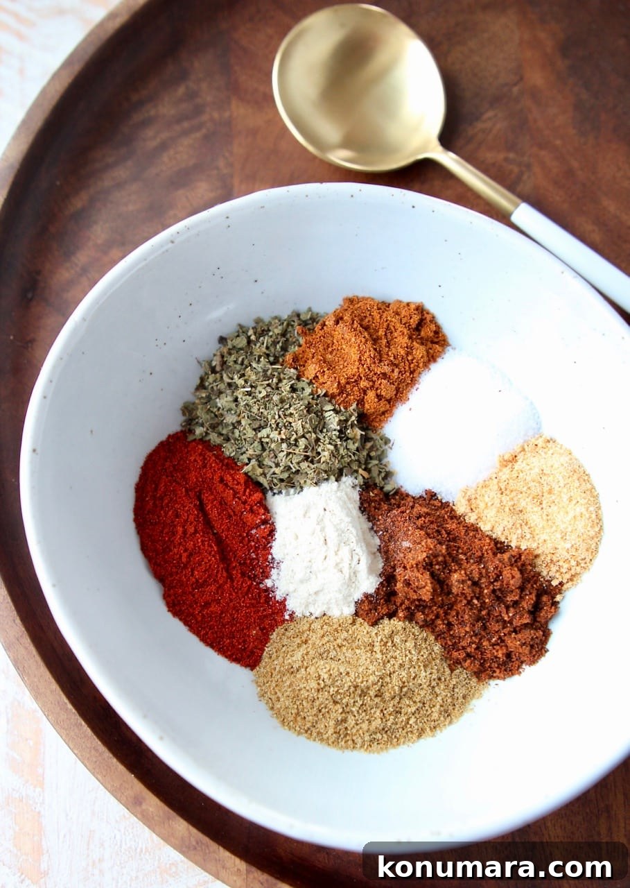 Homemade Fajita Seasoning Mix Recipe 2 Fajita seasoning spices in white bowl on wood tray