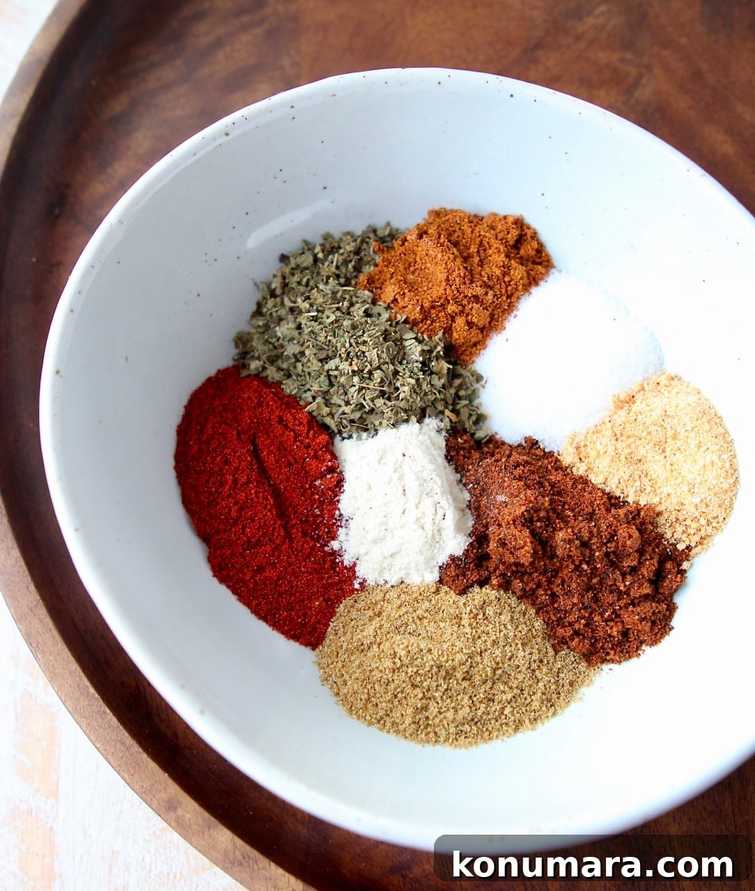 Homemade Fajita Seasoning Mix Recipe 5 spices separated in white bowl on brown serving tray