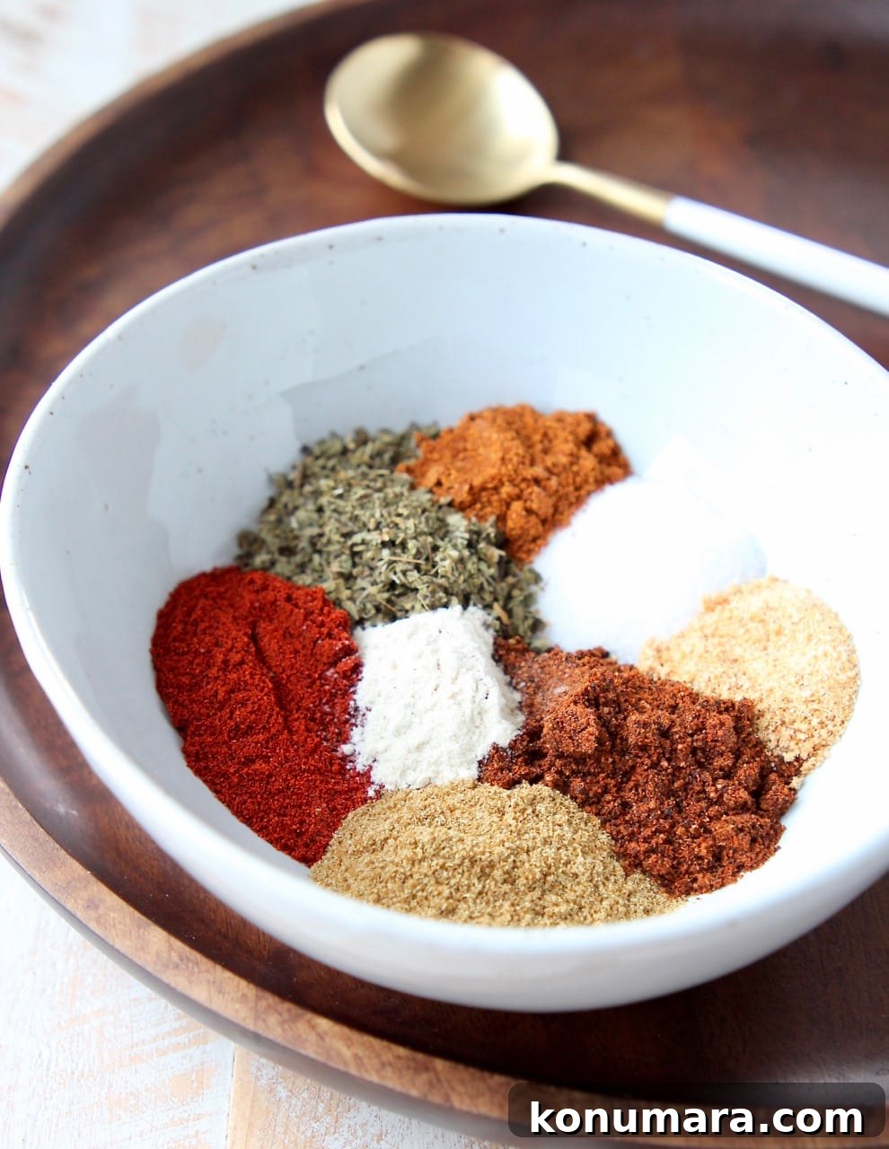 Homemade Fajita Seasoning Mix Recipe 7 Fajita seasoning spices separated in white bowl on wood tray