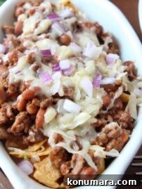 Classic Frito Chili Pie Recipe with Cheesy Corn Chip Topping 7 frito chili pie topped with cheese and diced red onion