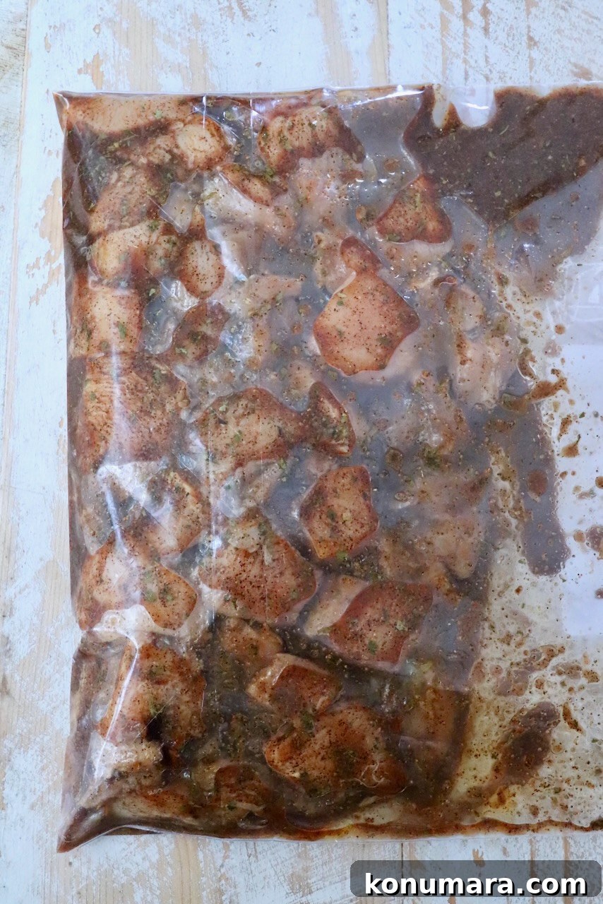 cubes of chicken marinating in a chipotle lime mixture in a zipper bag
