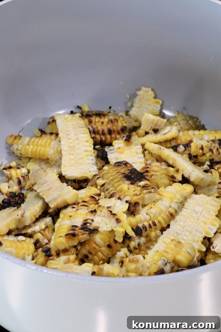 grilled corn kernels with char marks fill a white pot