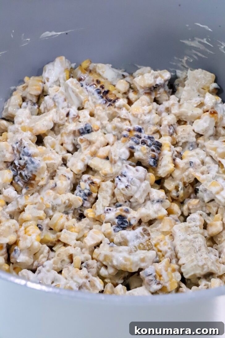 creamy mexican street corn in a white pot