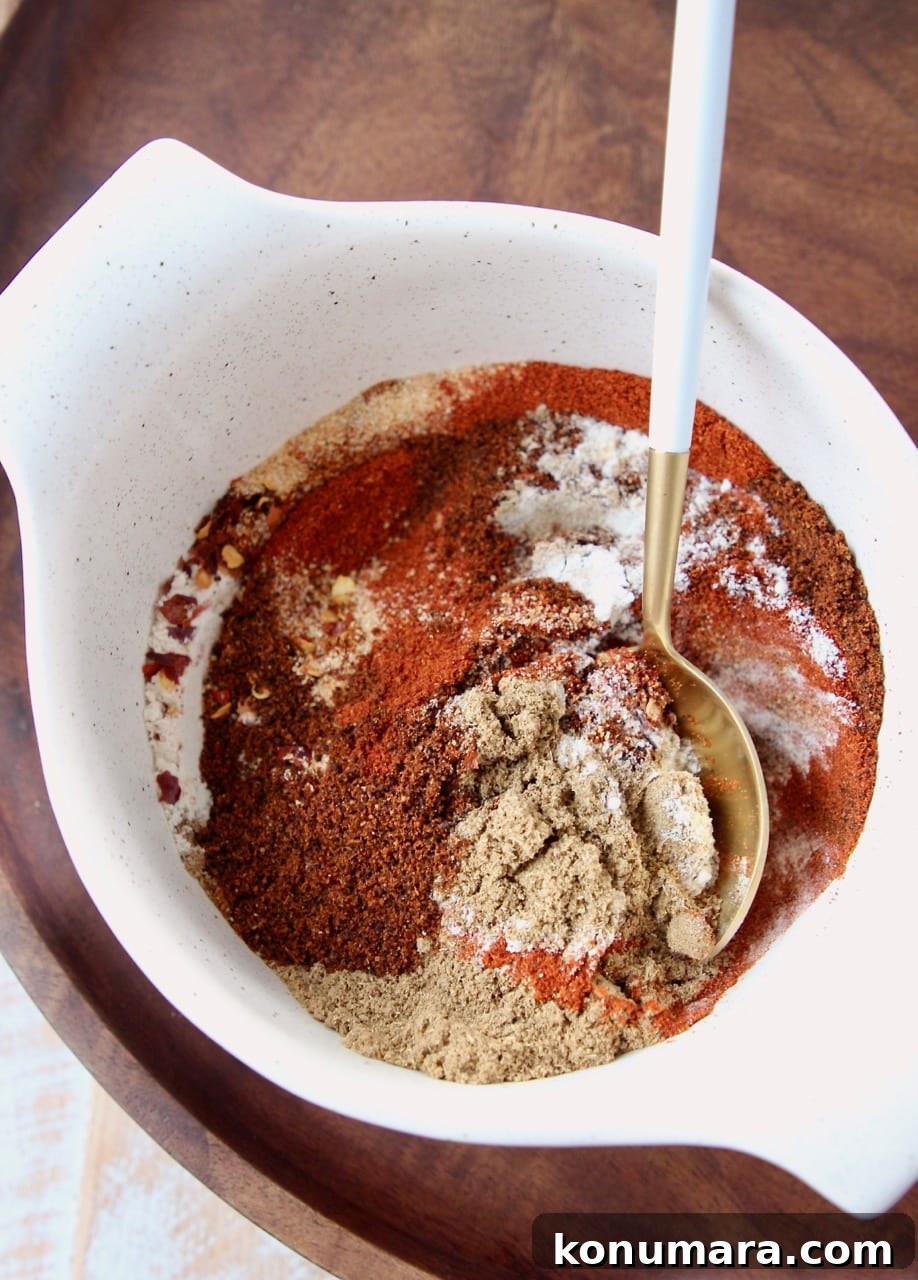 mix of spices in a bowl with a white and gold spoon