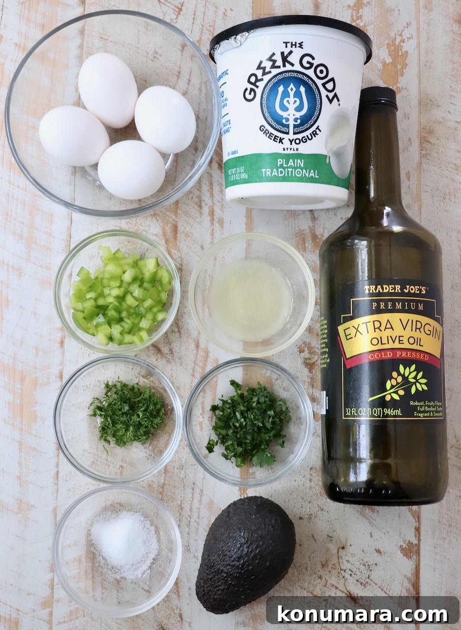 ingredients for avocado egg salad on white wood board