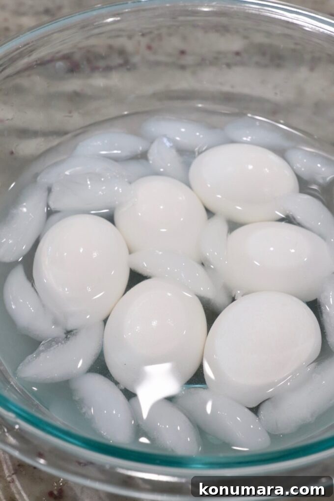 hard boiled eggs in glass bowl of ice water