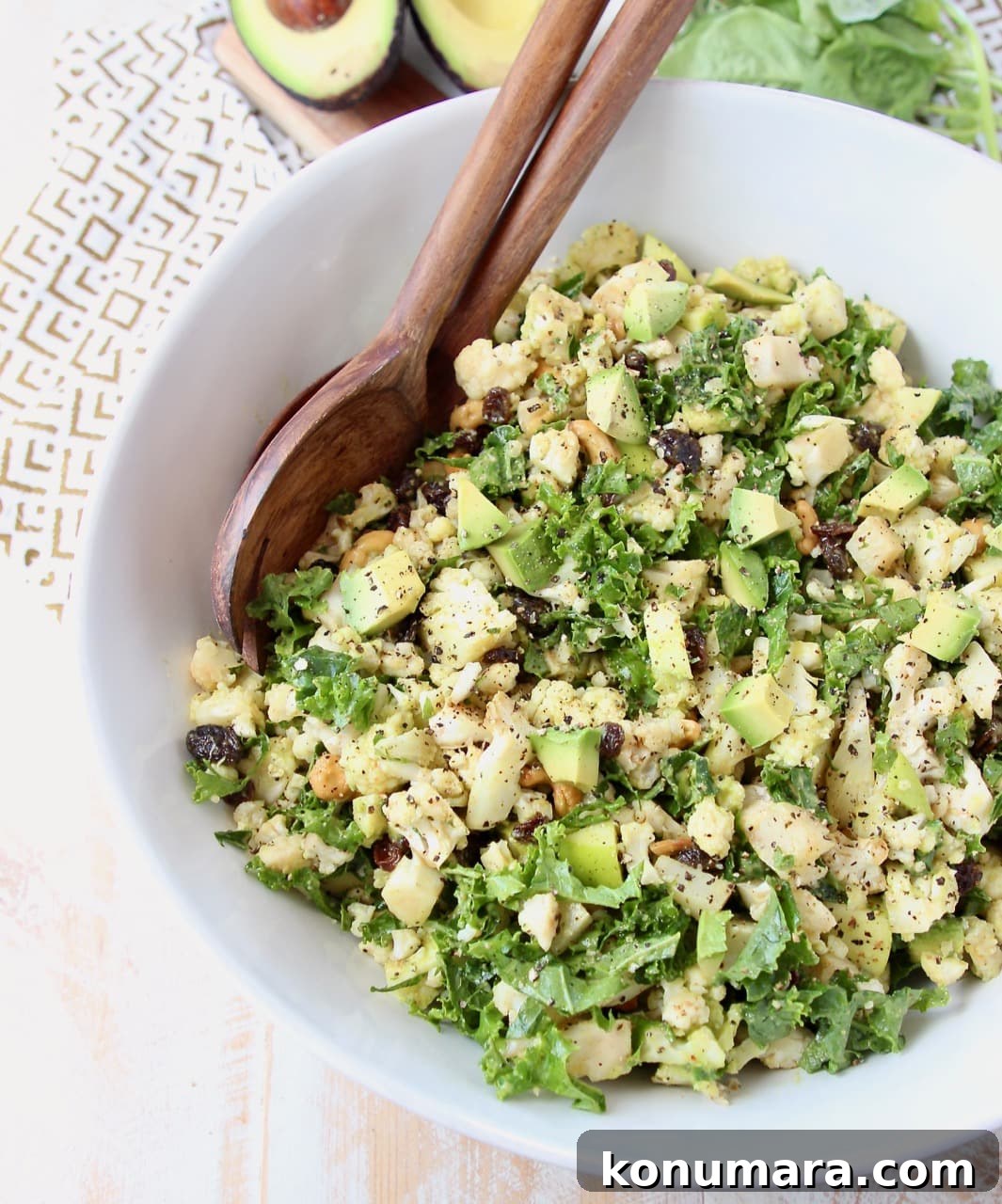 Roasted Cauliflower Salad with Lemon Tahini Dressing 3 Overhead shot of cauliflower salad with chopped kale and avocado in large white bowl