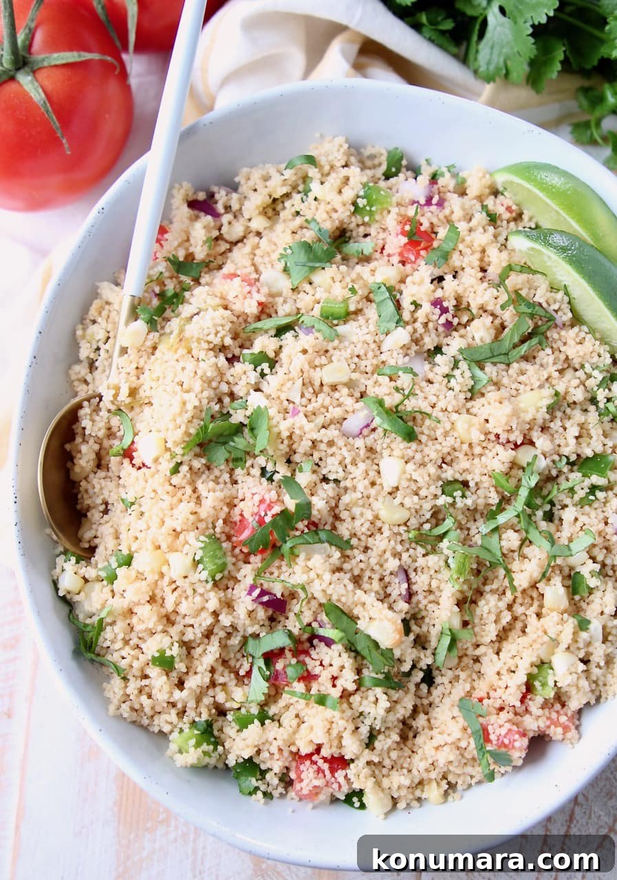 Roasted Tomatillo and Corn Couscous Recipe 3 Overhead shot of cooked couscous in bowl with cilantro, tomatoes and sliced limes
