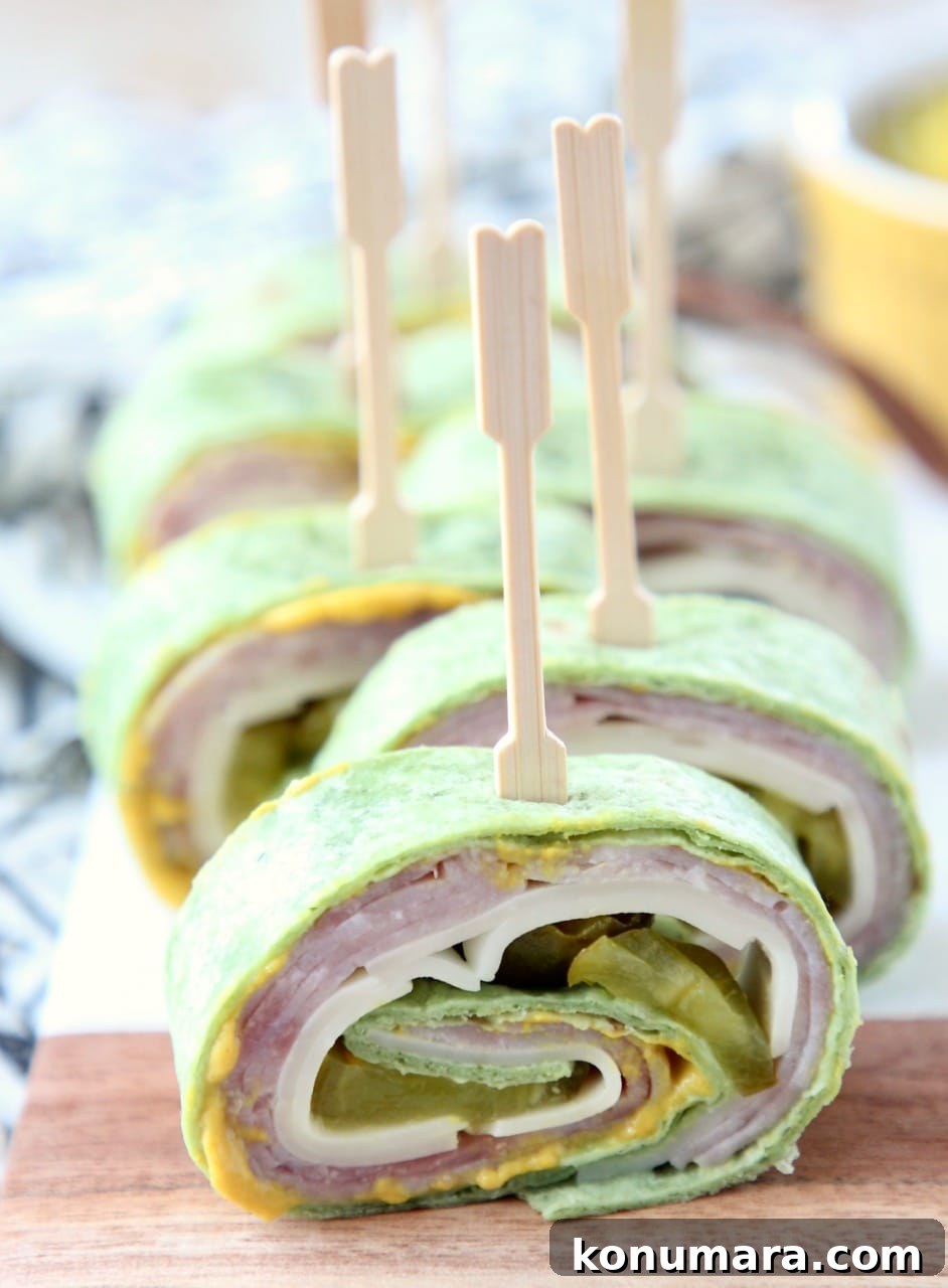 Cuban sandwich pinwheels on cutting board with toothpicks