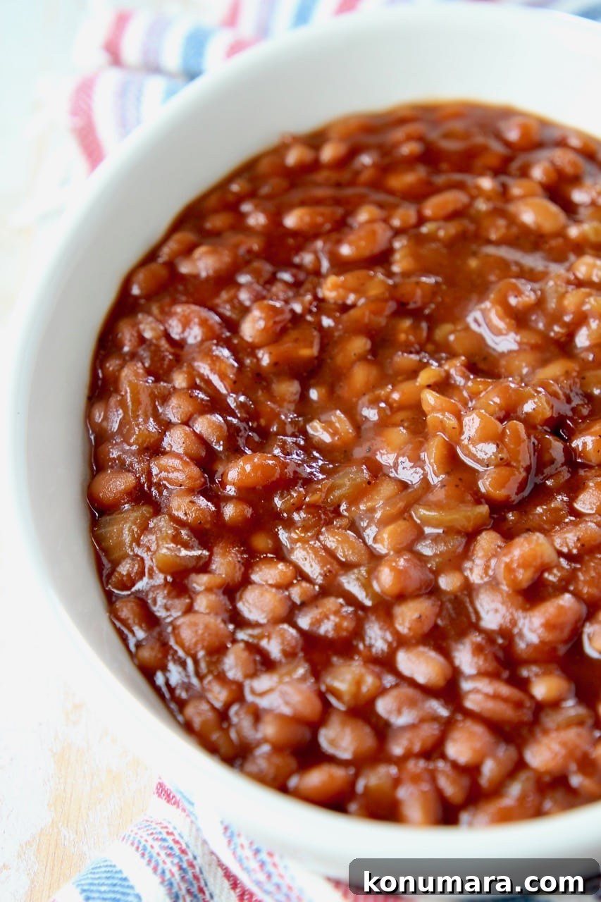 Dad's Signature Smoky BBQ Baked Beans Recipe 4 BBQ baked beans in oval bowl