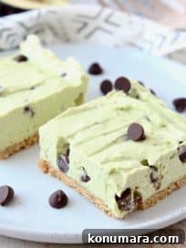 Frozen avocado cheesecake bars on plate with chocolate chips