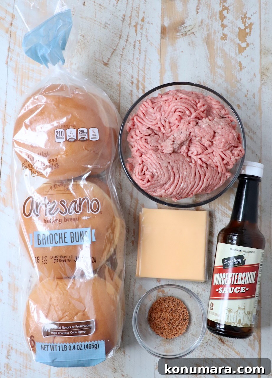 ingredients for juicy lucy burgers on white wood board