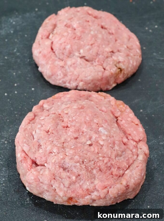 stuffed burger patties on a cutting board