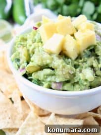 Guacamole in white bowl topped with diced pineapple