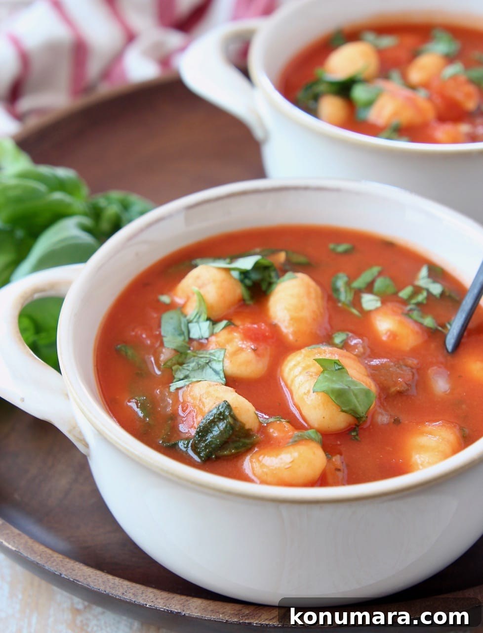Creamy Tomato Basil Gnocchi Soup Recipe 3 Tomato basil gnocchi soup in white bowls with spoons