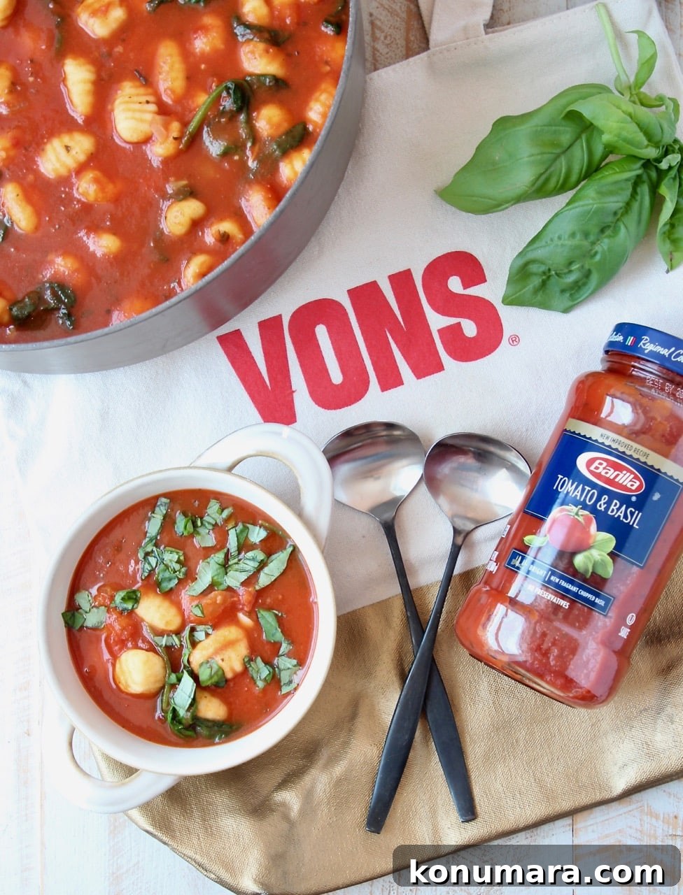 Creamy Tomato Basil Gnocchi Soup Recipe 4 Bowl of soup, sitting on Vons bag with two spoons and jar of tomato sauce