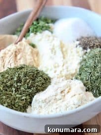Ranch seasoning ingredients in a bowl with a spoon
