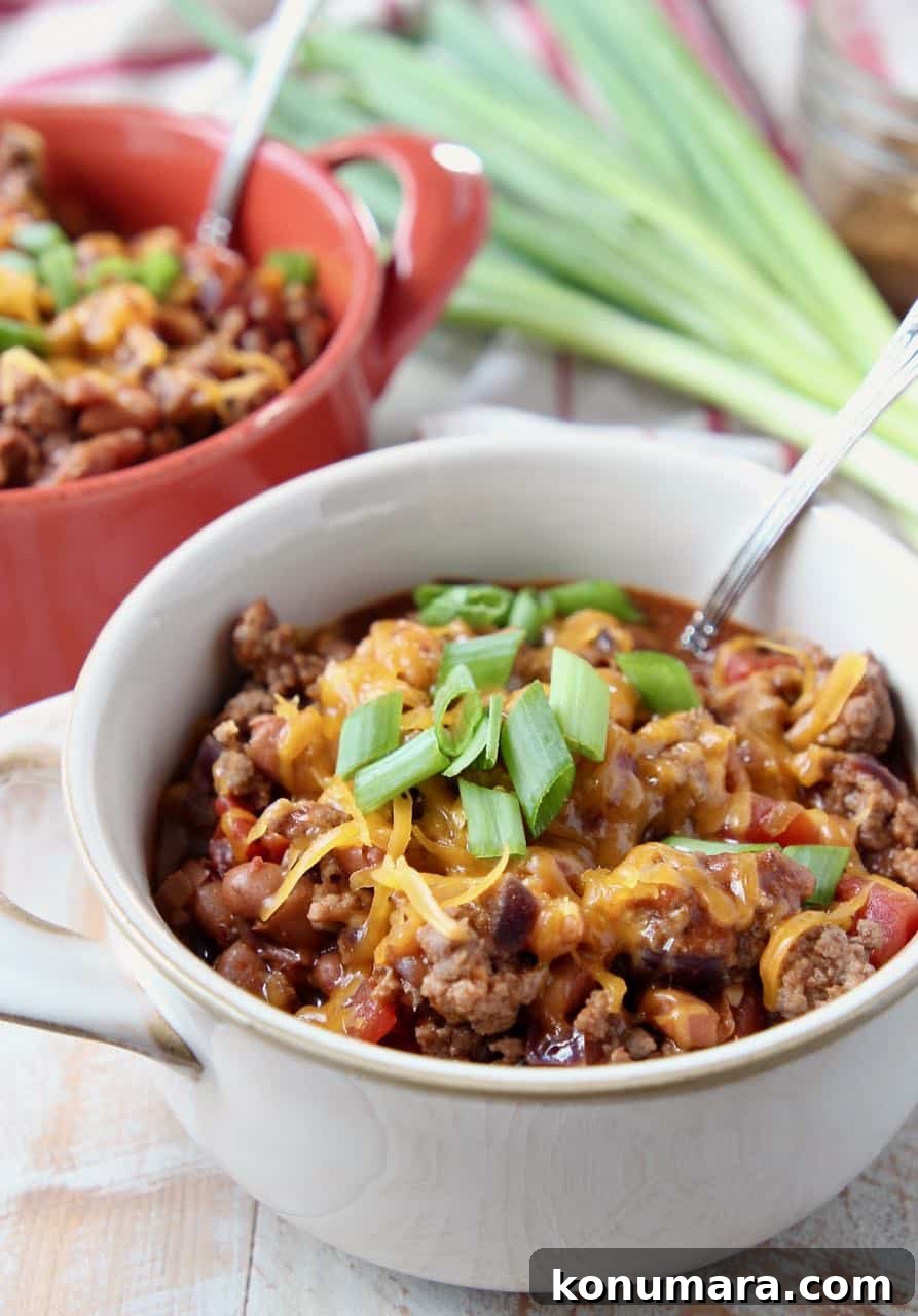 Chili in small crock bowls with silver spoon in the bowl