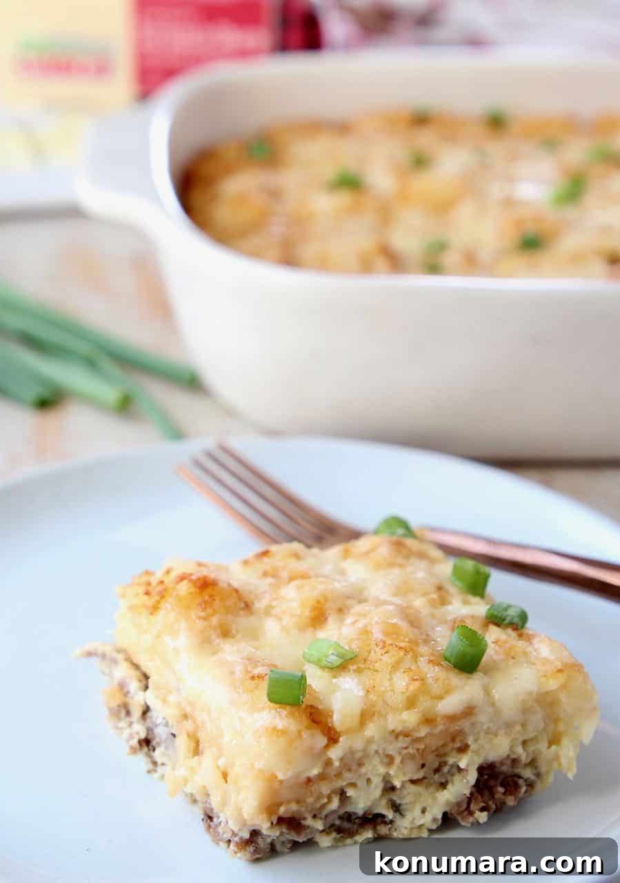 Slice of breakfast tater tot casserole on plate with fork