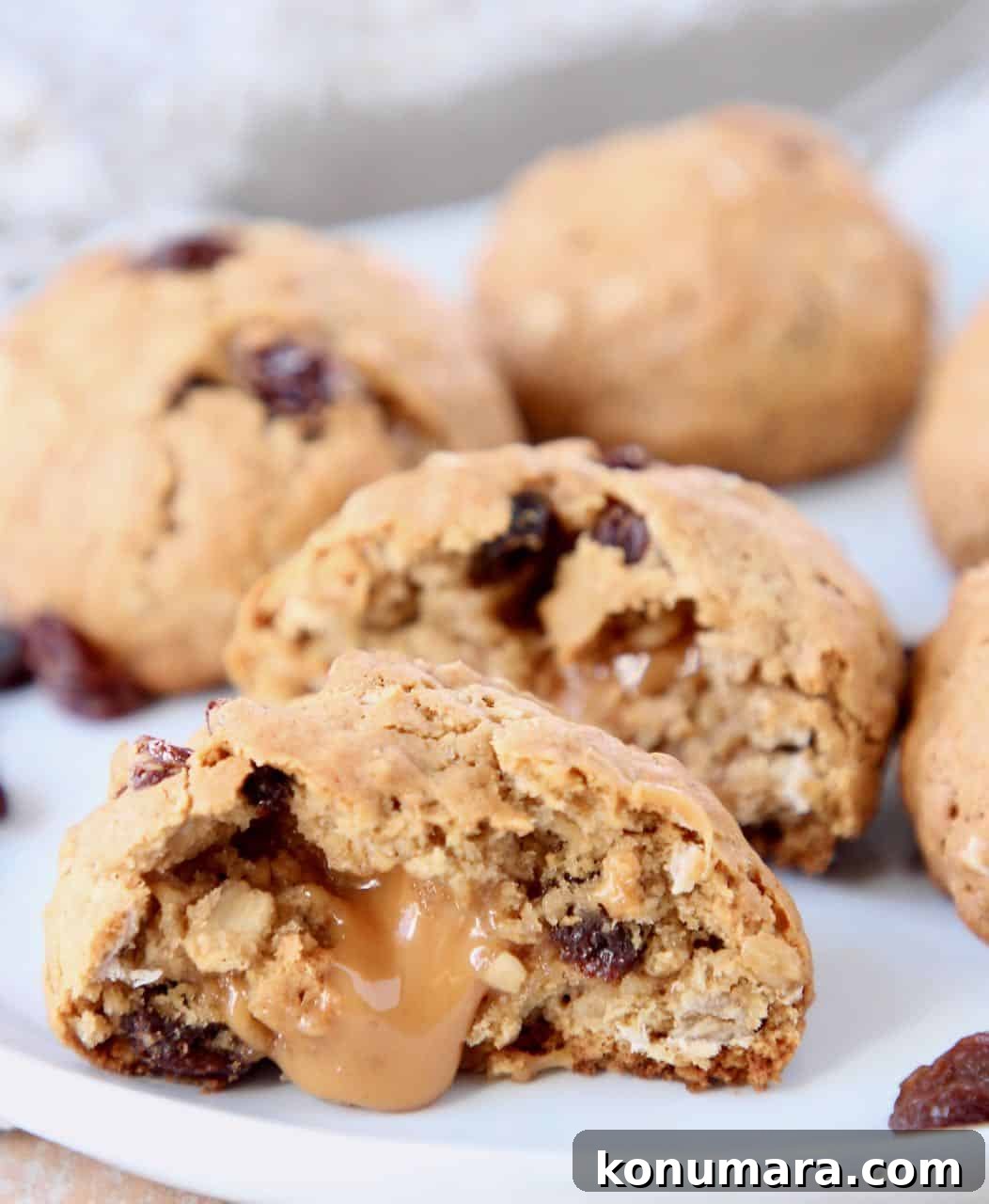 Oatmeal raisin cookie cut in half with a caramel center