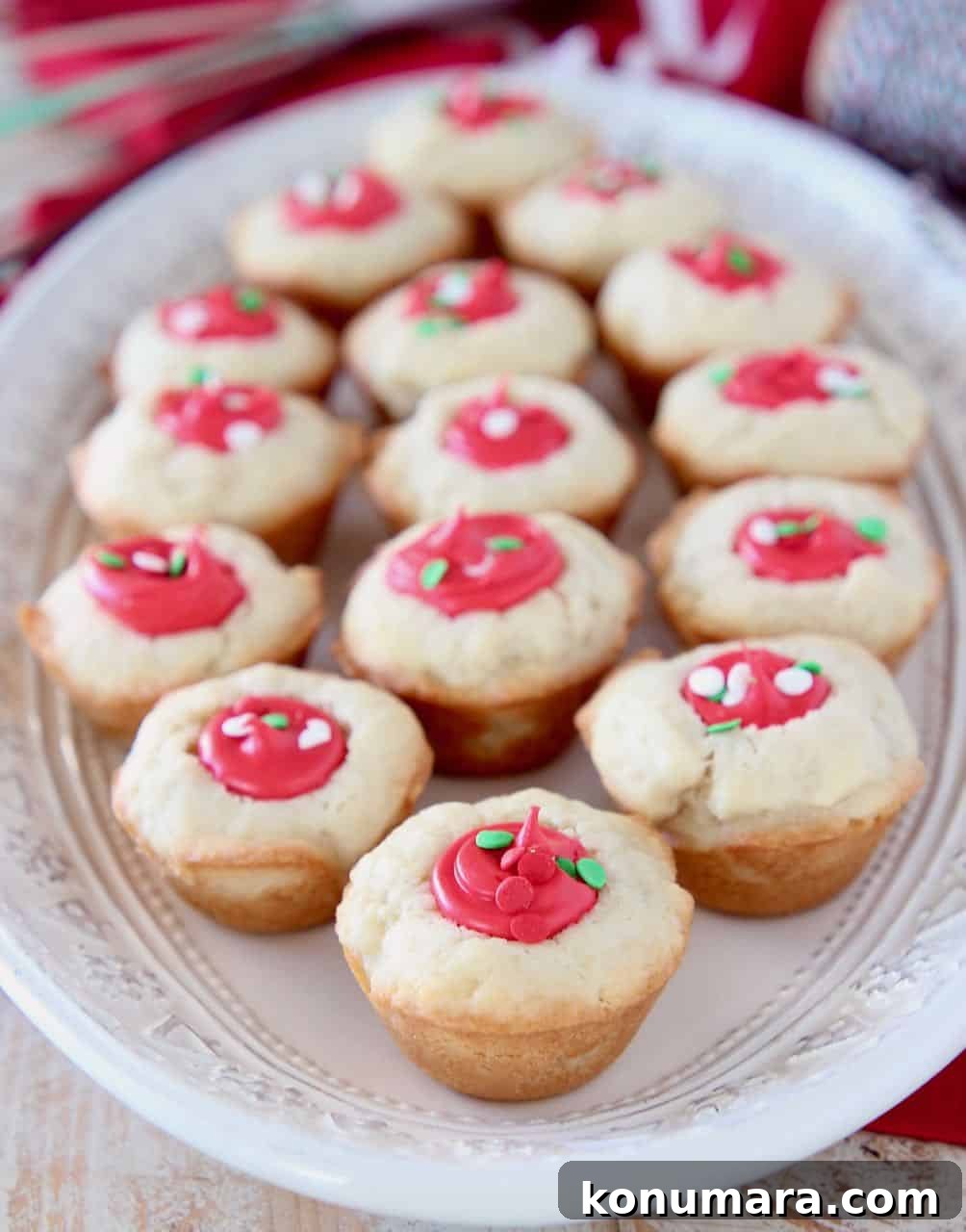 Sugar cookie cups filled with red frosting on white plate