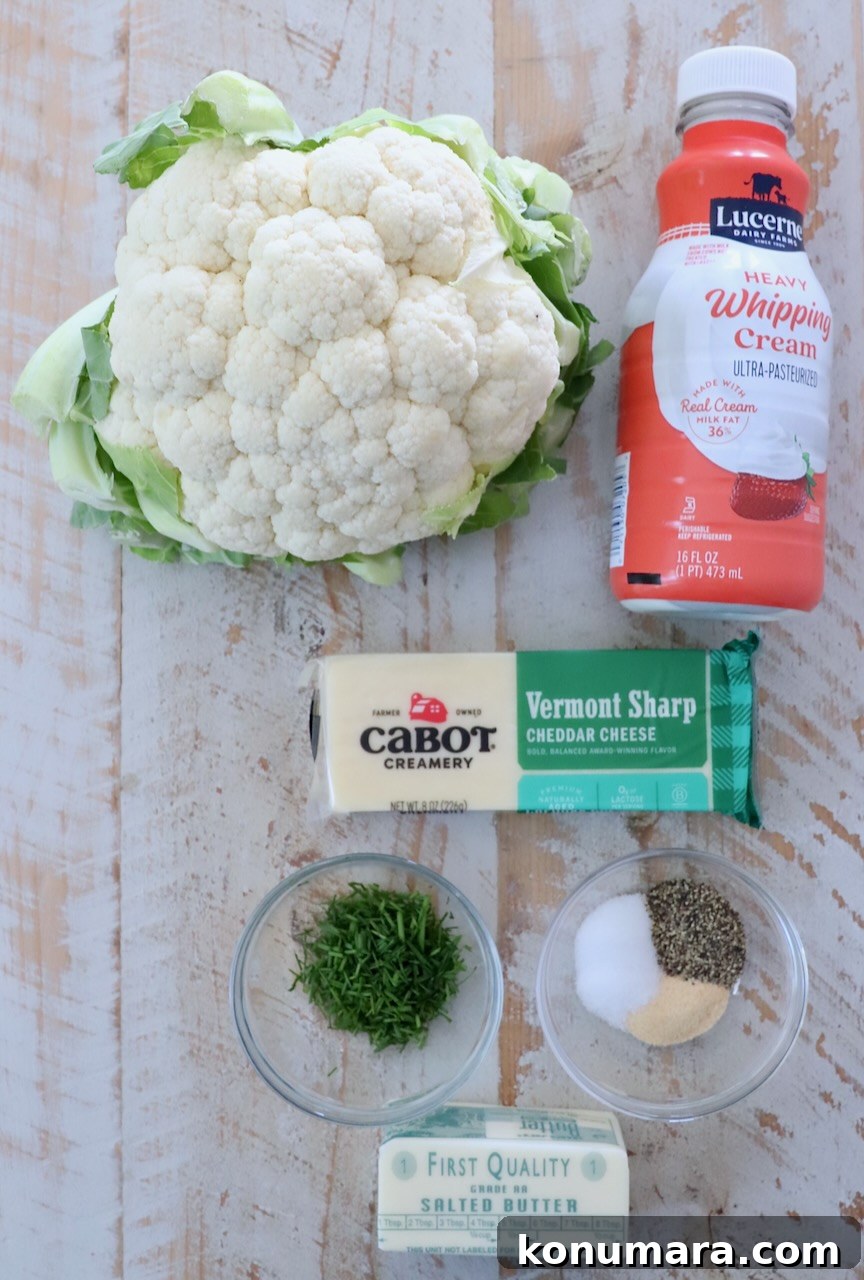 ingredients for mashed cauliflower on a white wood board