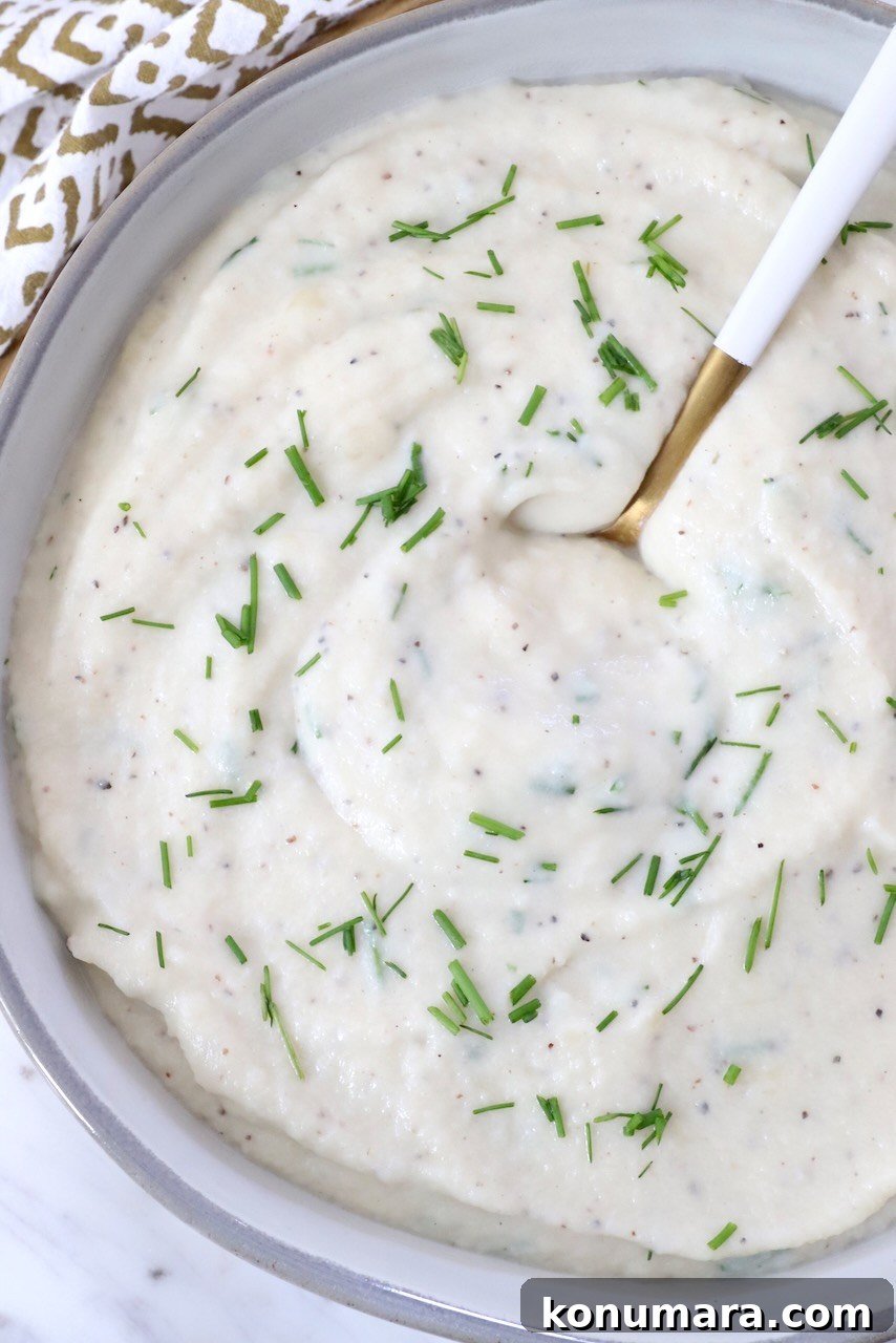 mashed cauliflower in a bowl with a spoon