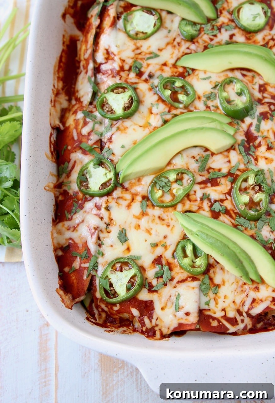 19 New Recipes from 2019 Worth Revisiting 15 Overhead shot of enchiladas covered in red sauce and cheese in baking dish topped with avocado and jalapenos