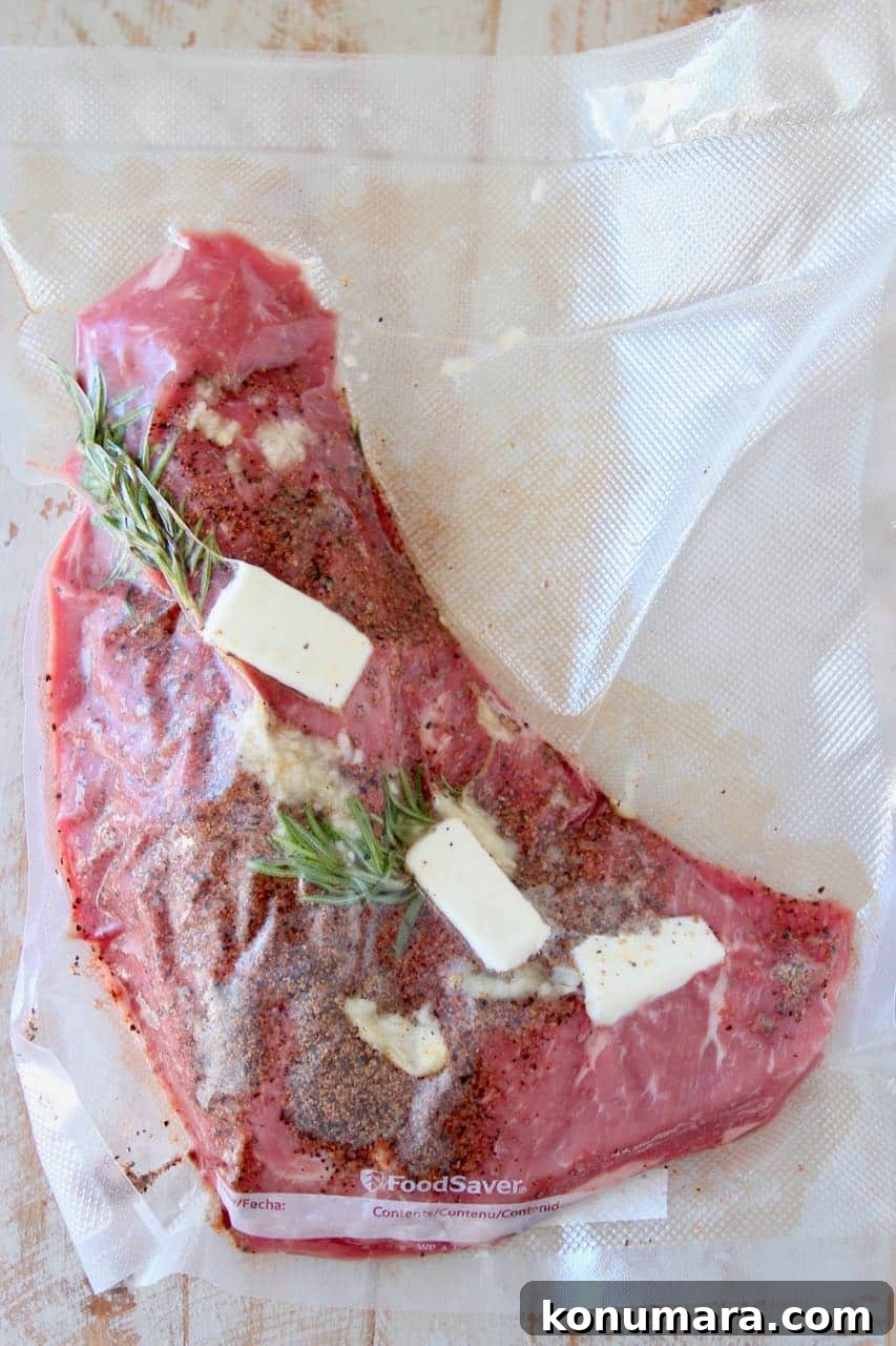 Tri tip steak vacuum sealed in bag with butter and fresh herbs
