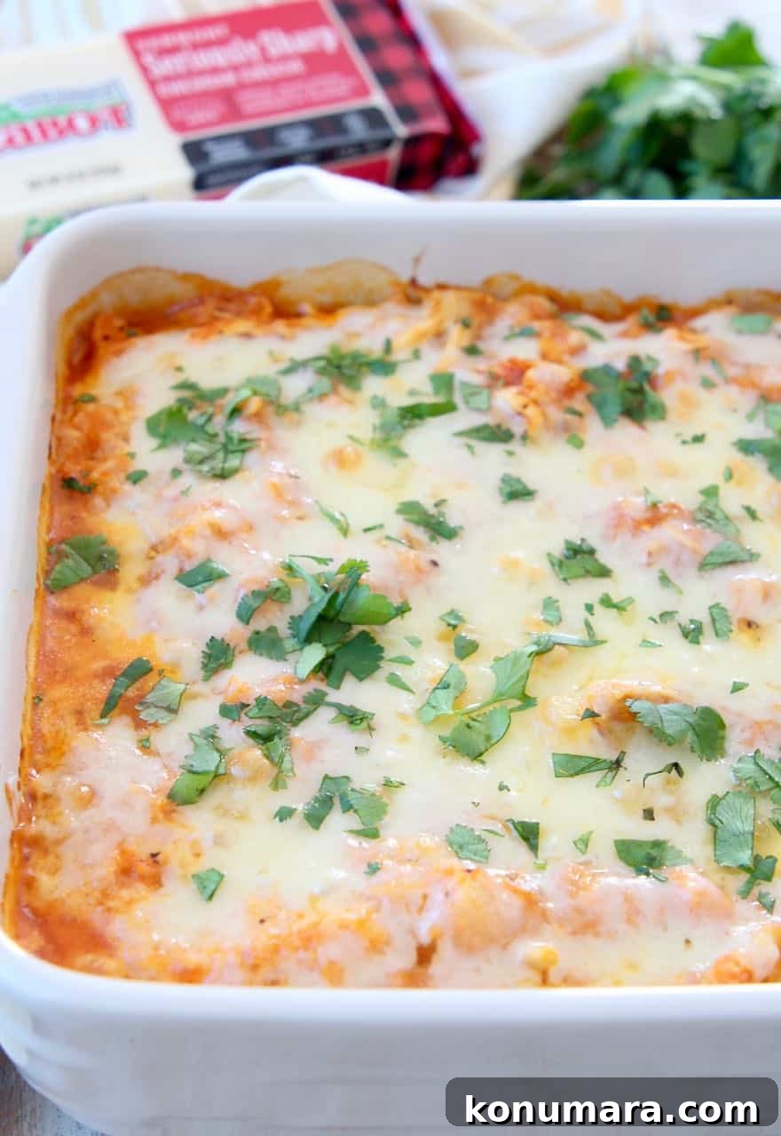 Cheesy cauliflower casserole in baking dish, topped with fresh cilantro