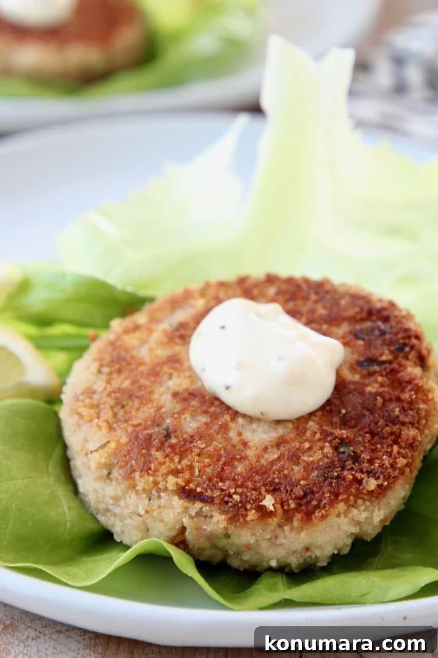 Crispy tuna cake on leaf of butter lettuce, topped with garlic aioli