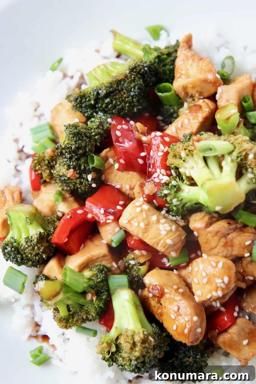 Teriyaki chicken and broccoli on top of rice on plate