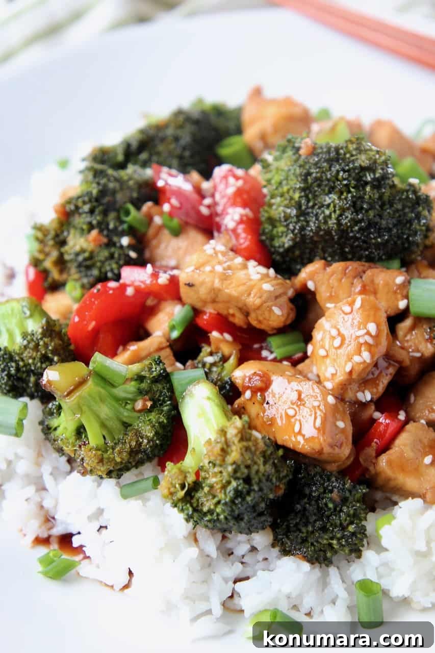 Teriyaki chicken pieces and broccoli over rice on plate
