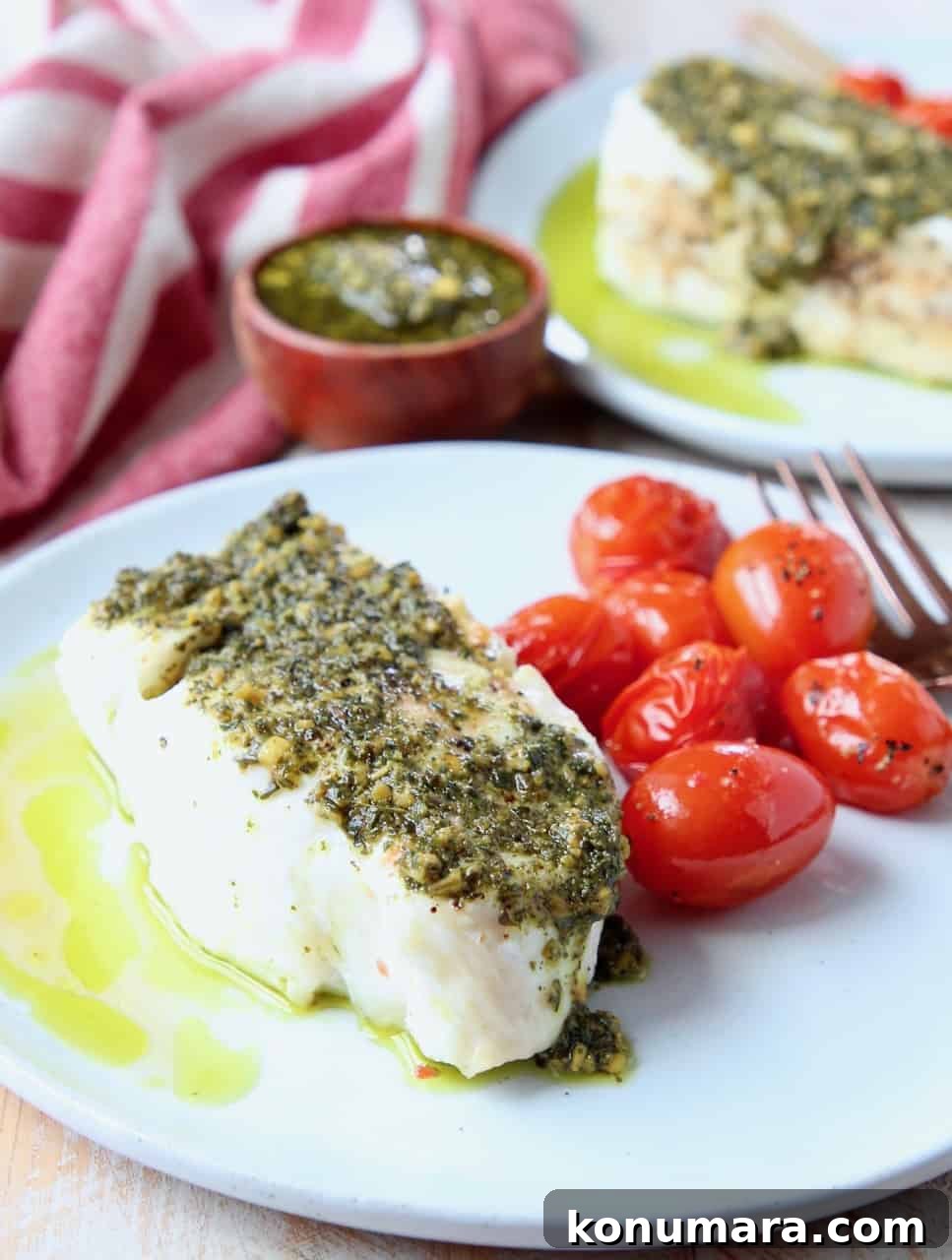 Baked Chilean Sea Bass with Basil Pesto Recipe 3 Sea bass topped with pesto on plate with cherry tomatoes