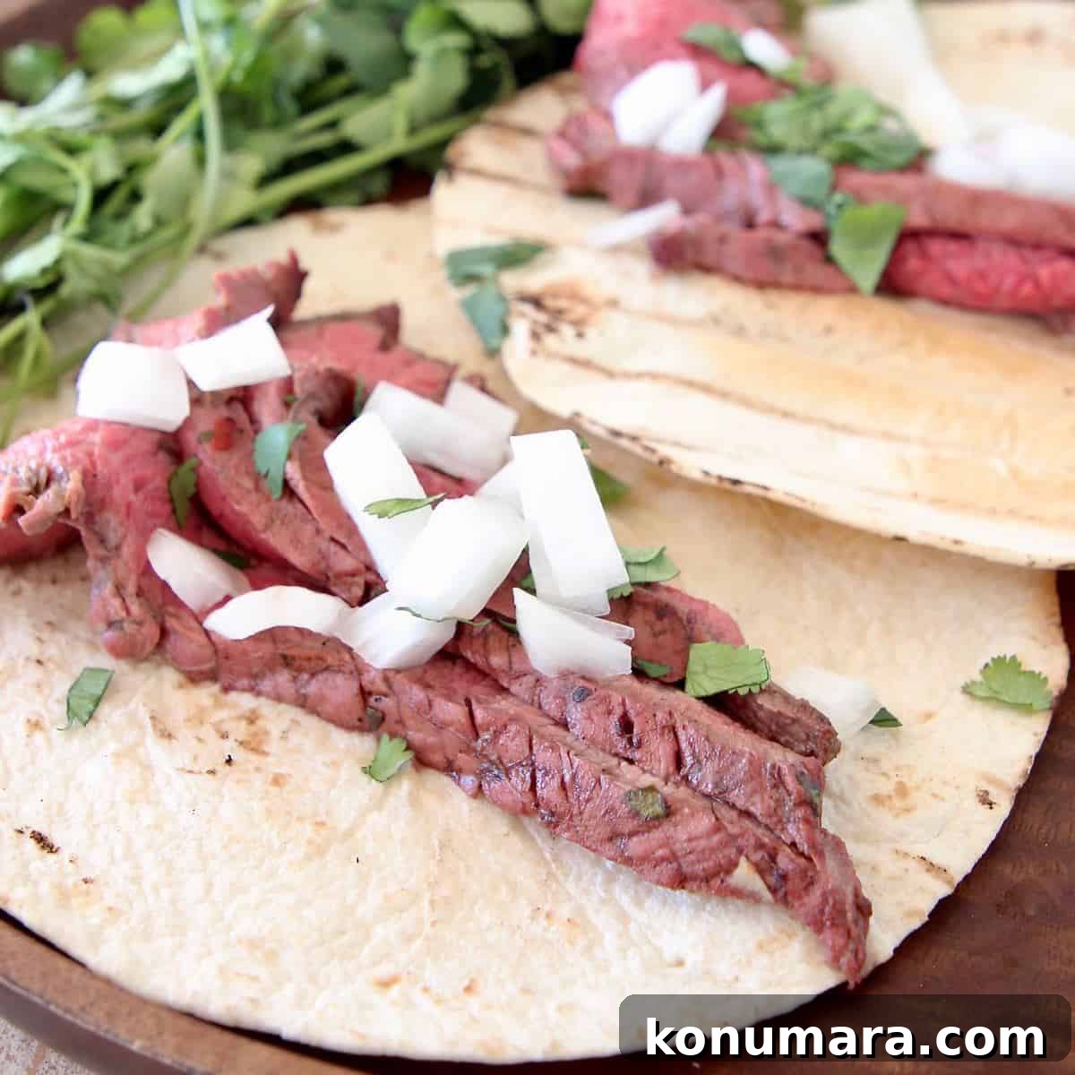 Grilled Citrus-Marinated Carne Asada 3 Sliced carne asada in tortillas