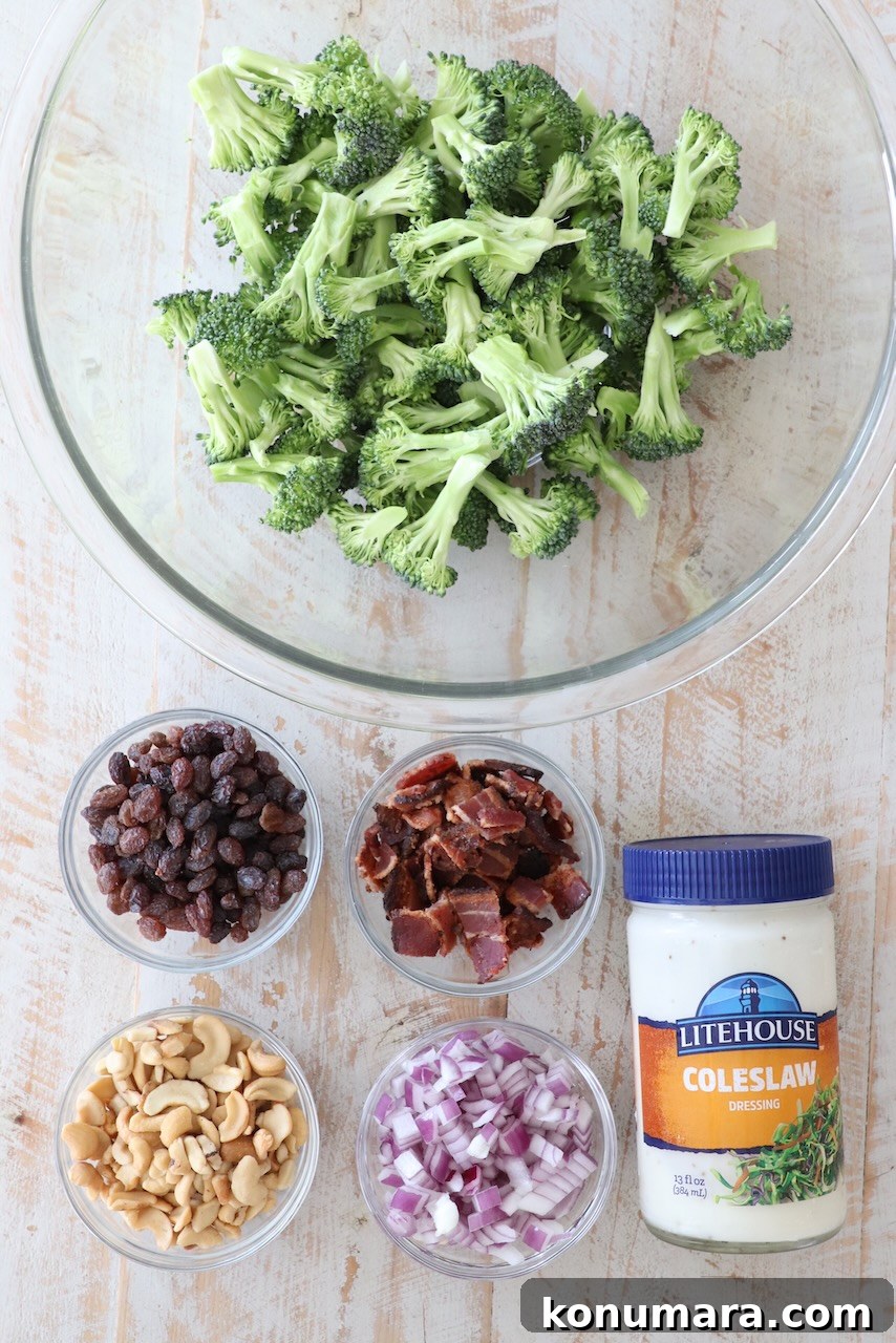 Ingredients for broccoli salad on white wood board