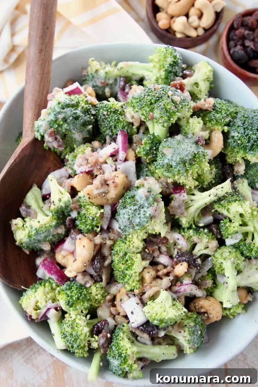 Broccoli salad in bowl with large wooden serving spoon