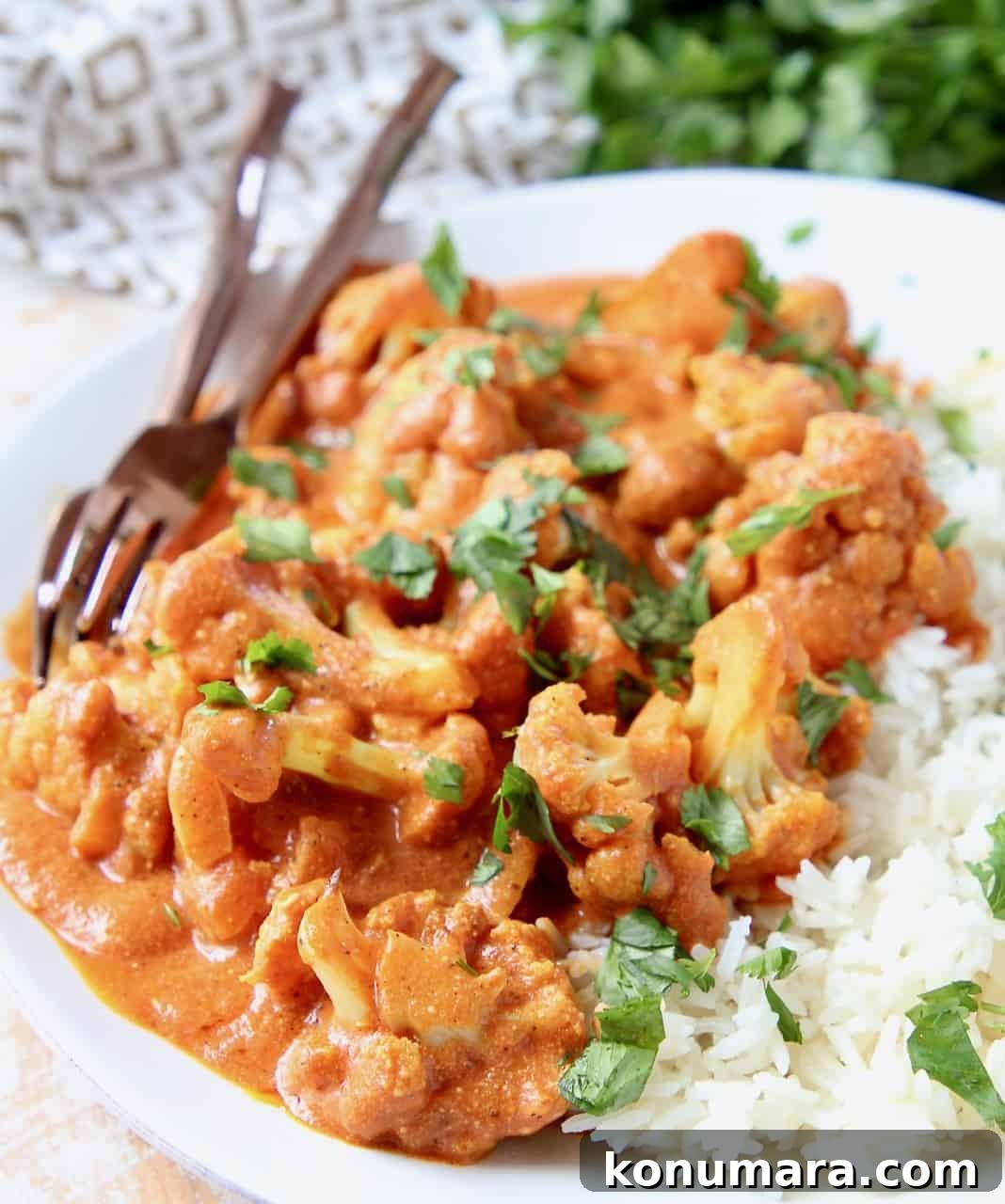 Creamy Indian Butter Cauliflower Curry Recipe 3 Cauliflower florets on plate covered in curry sauce