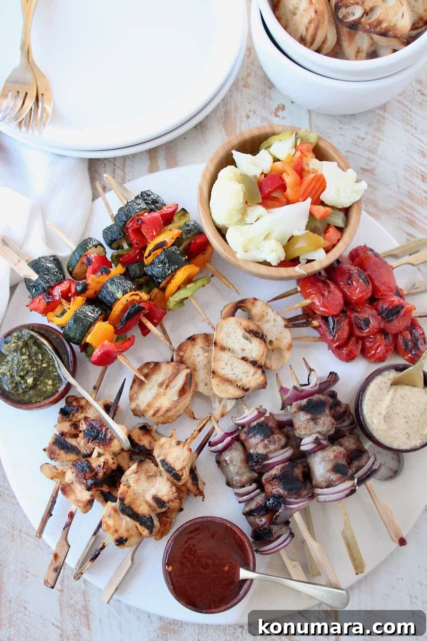 Grilled Charcuterie Board with Mini Skewers for Parties 4 Overhead image of grilled mini skewers on charcuterie board with small bowls of sauces