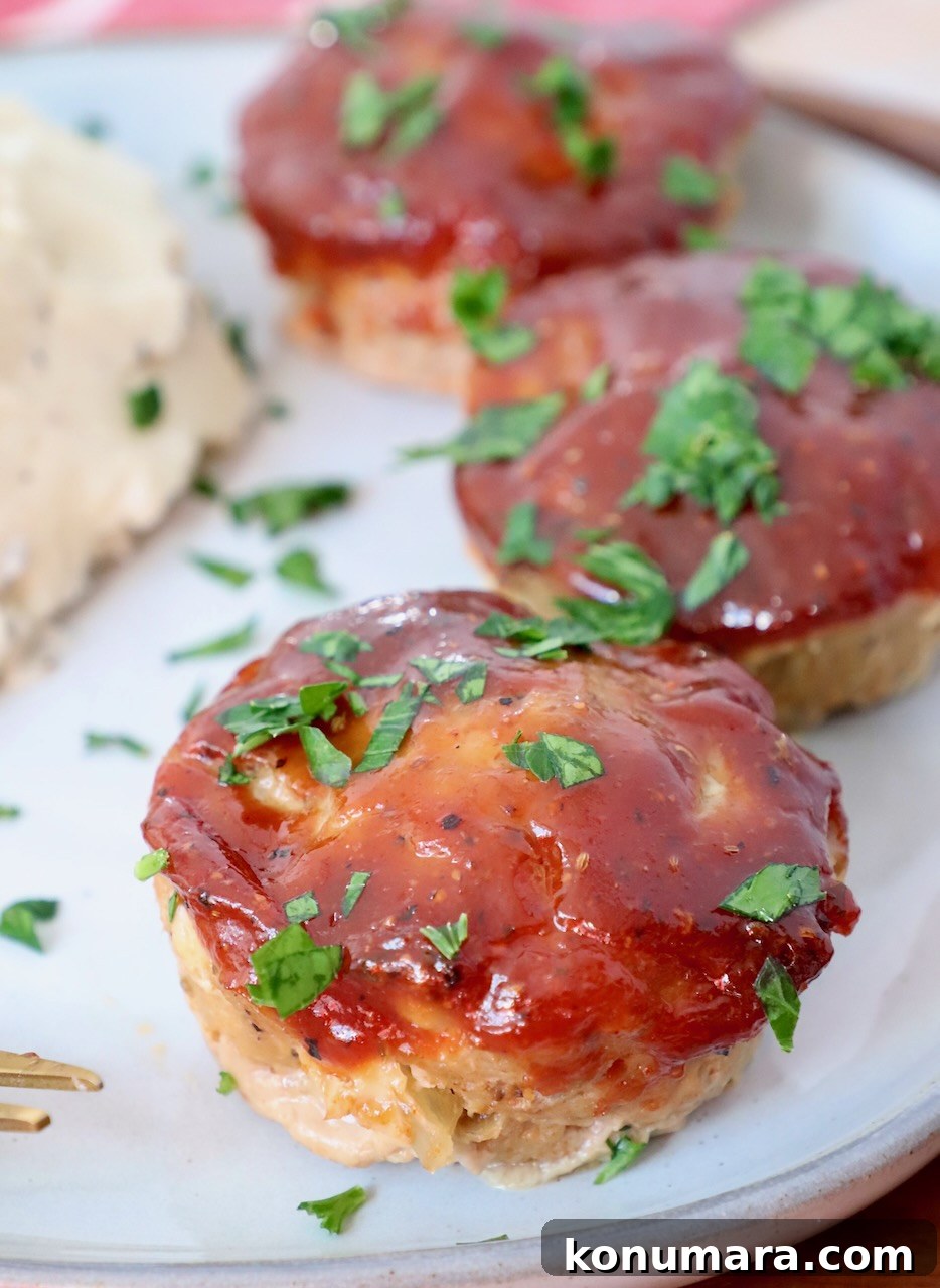 Maple-Glazed Mini Meatloaves Recipe 2 mini meatloaves on plate