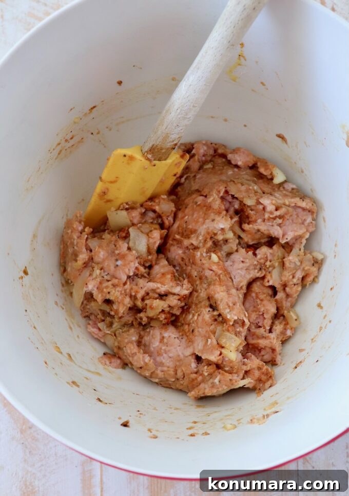 Maple-Glazed Mini Meatloaves Recipe 5 ground turkey mixed with spices, breadcrumbs and egg in a large mixing bowl