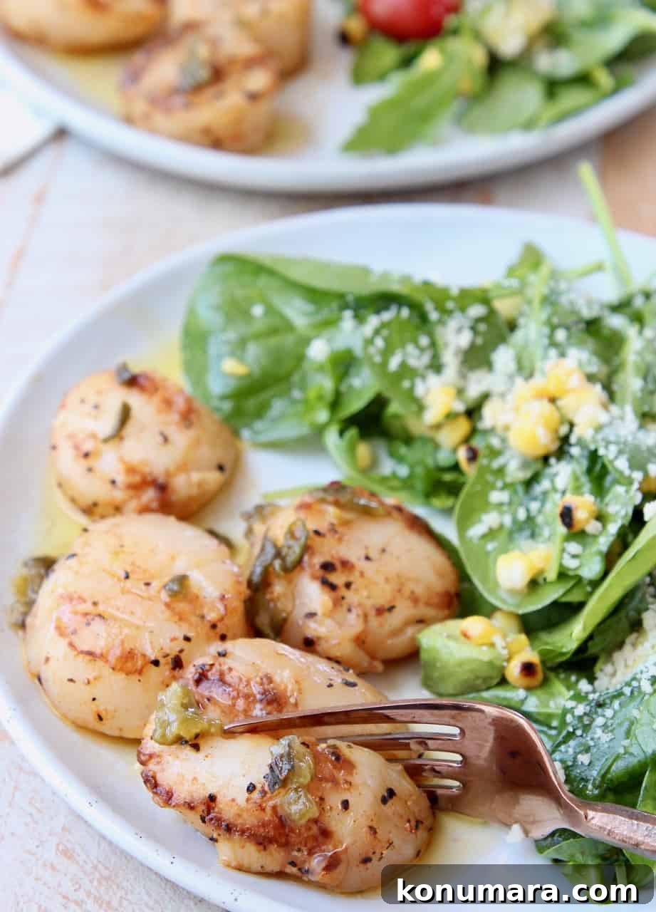 Grilled Scallops in Spicy Jalapeño-Lemon Butter Sauce 5 Grilled scallop being sliced with fork