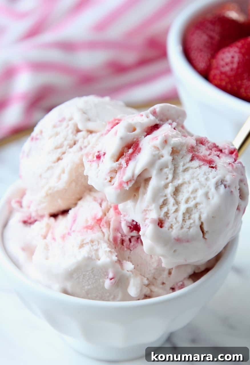 Creamy No-Churn Strawberry Ice Cream Recipe 2 Scoops of strawberry ice cream in white bowl