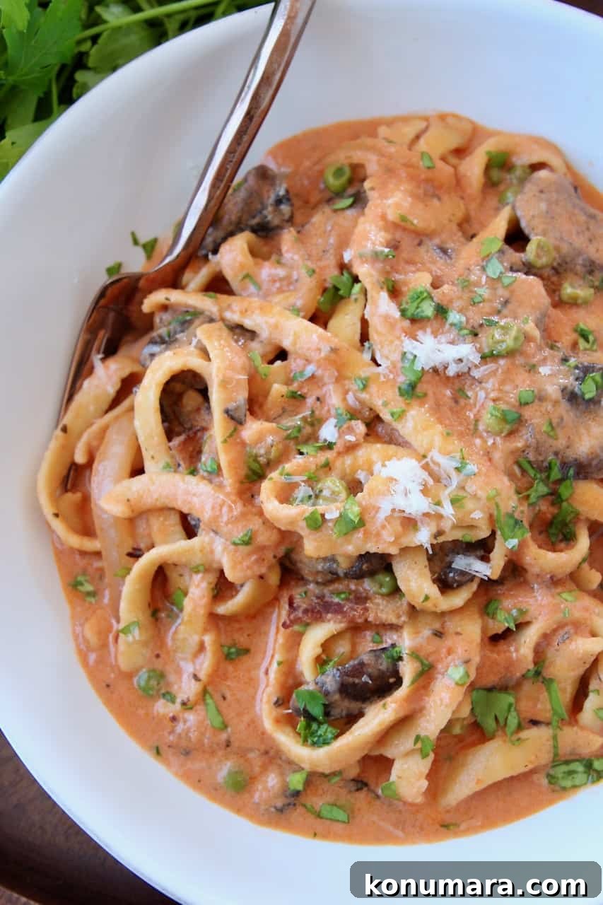 Pasta Boscaiola: Creamy Mushroom and Bacon Sauce 2 Overhead image of pasta in creamy tomato mushroom sauce