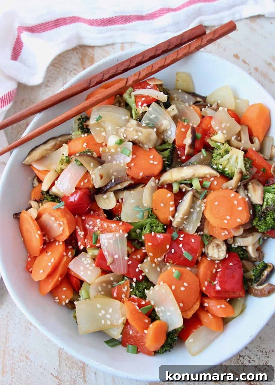 Soy Ginger Glazed Roasted Asian Vegetables Recipe 5 Overhead image of roasted Asian vegetables in white bowl with chopsticks on the side