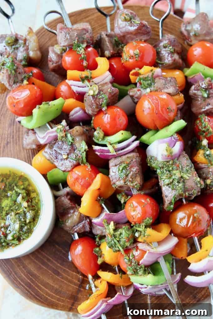 Grilled Ribeye Steak Kabobs with Chimichurri Sauce Recipe 2 Grilled steak and vegetable skewers on wood cutting board