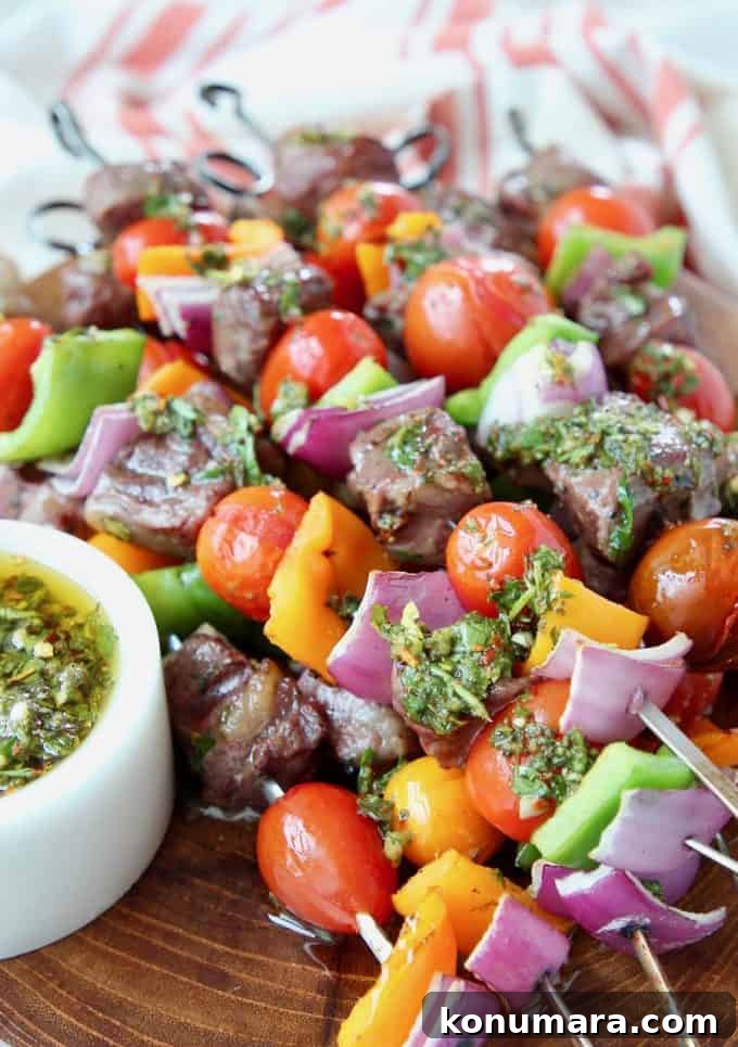 Grilled Ribeye Steak Kabobs with Chimichurri Sauce Recipe 5 Steak and veggie skewers piled up on wood cutting board